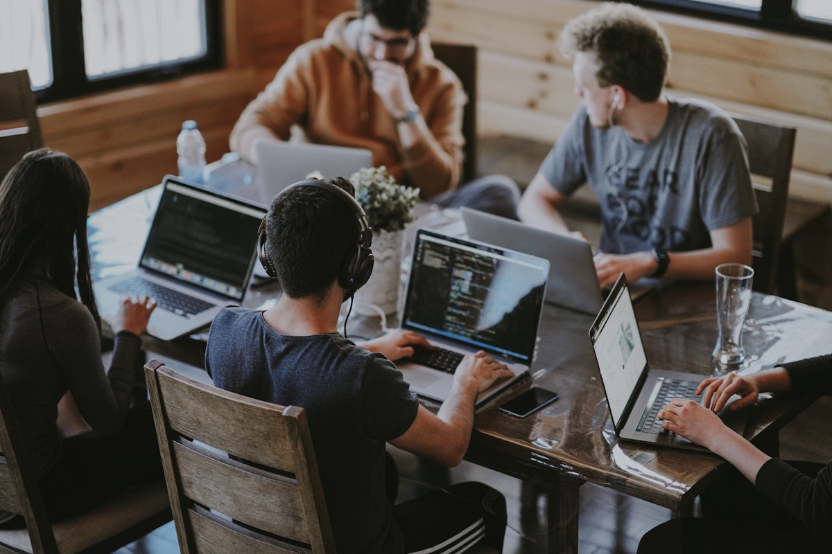 A group of teammates working together on laptops