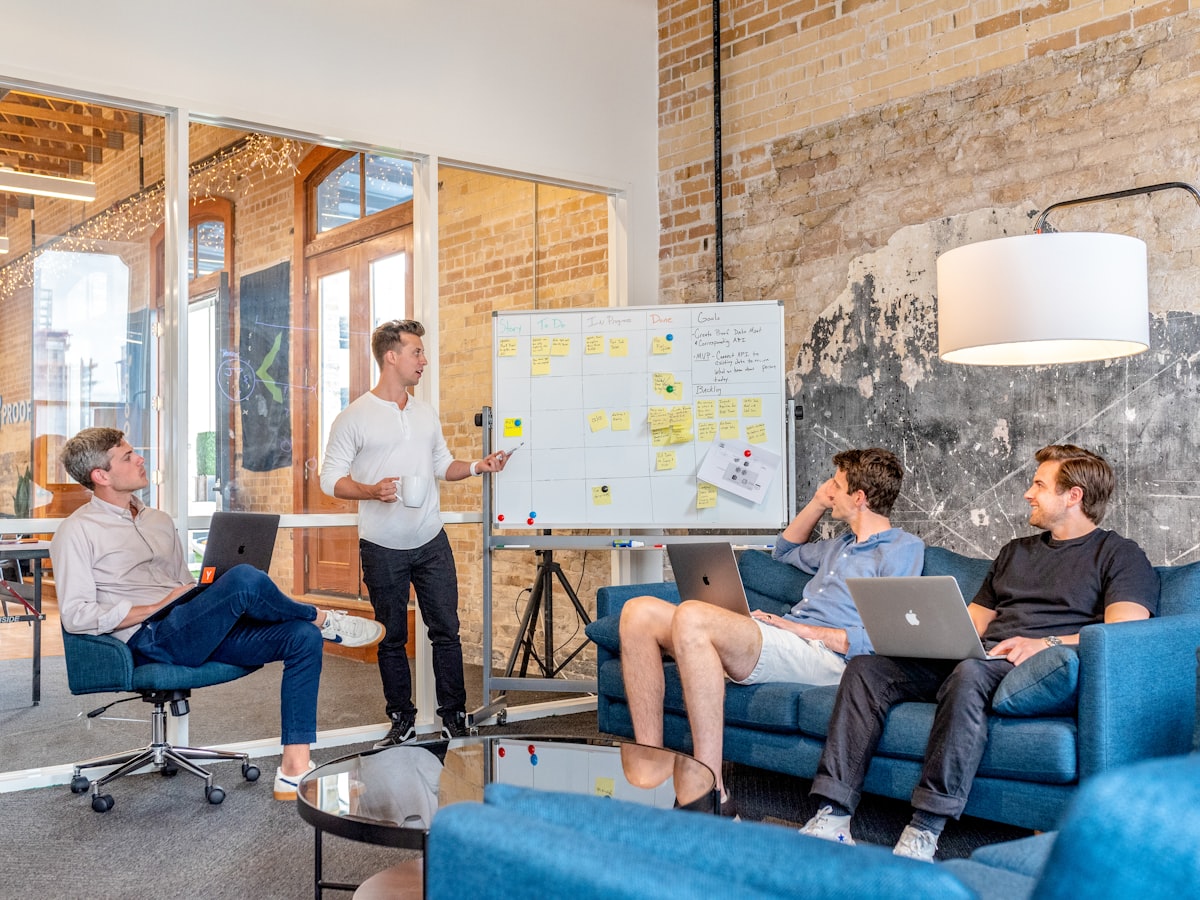 A team working through a strategy session by a whiteboard
